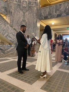 Couple walking down courthouse steps after ceremony