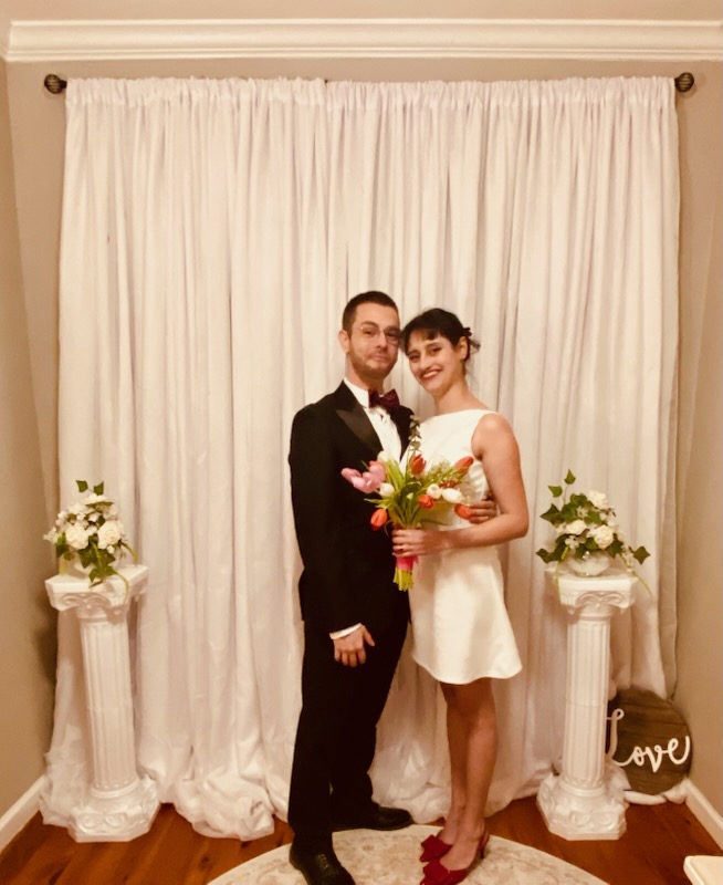 Joyful newlywed couple exchanging vows with Twin Flames officiant